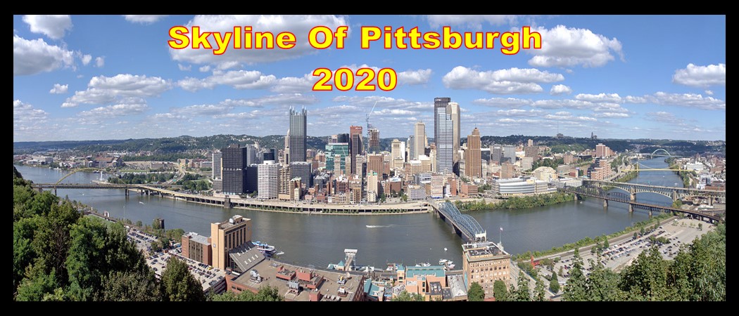 Skyline of Pittsburgh from Mt Washington showing Smithfield, Ft Pitt Bridge and 4 other bridges with white clouds and blue sky in 2020